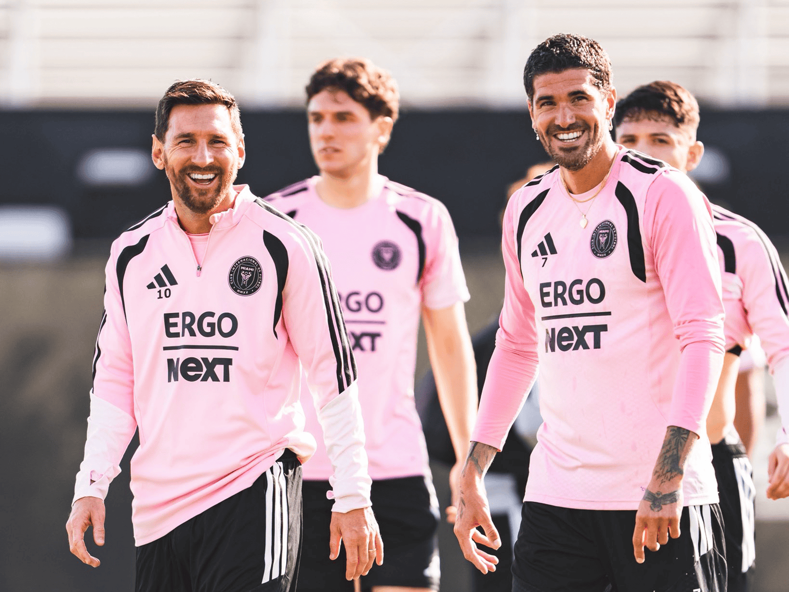 Happy Inter Miami players in team jerseys during training or match.